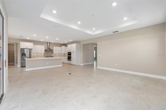 10026 SW 85th Place Rd, Ocala, FL 34481 - unfurnished living room with recessed lighting, a raised ceiling, and light tile patterned floors