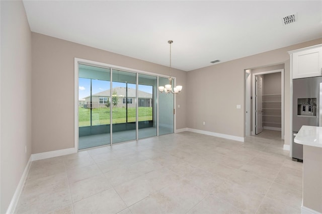 10026 SW 85th Place Rd, Ocala, FL 34481 - unfurnished room with a chandelier and light tile patterned floors