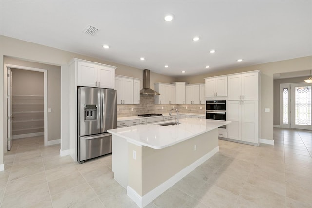 10026 SW 85th Place Rd, Ocala, FL 34481 - kitchen with stainless steel appliances, wall chimney range hood, white cabinets, decorative backsplash, and recessed lighting