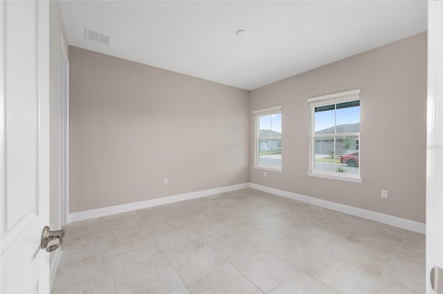 10026 SW 85th Place Rd, Ocala, FL 34481 - empty room with baseboards and light tile patterned flooring