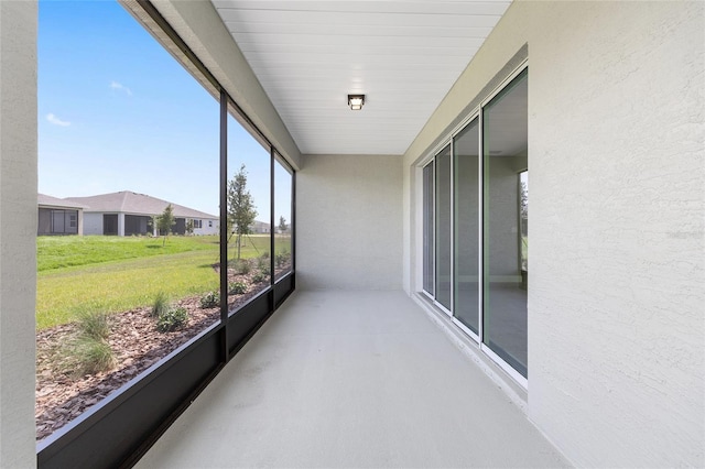 10026 SW 85th Place Rd, Ocala, FL 34481 - unfurnished sunroom featuring finished concrete flooring and a textured wall