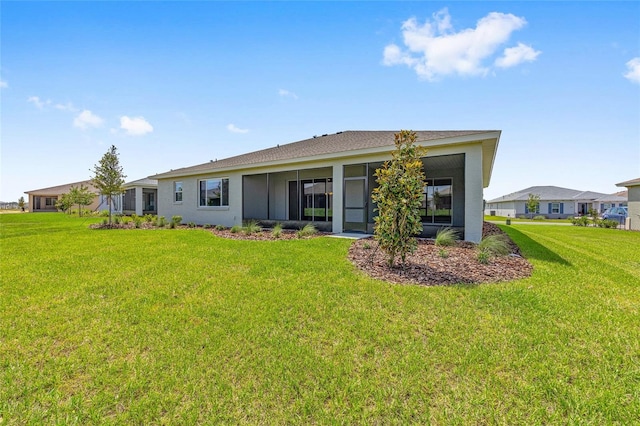 10026 SW 85th Place Rd, Ocala, FL 34481 - back of property featuring a lawn, a sunroom, and stucco siding