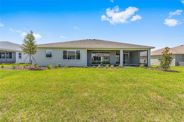 10026 SW 85th Place Rd, Ocala, FL 34481 - rear view of house featuring a lawn, a sunroom, stucco siding, and a shingled roof