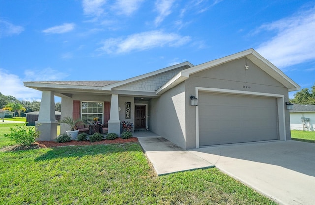 11330 SW 61st Cir, Ocala, FL 34476 - ranch-style home with stucco siding, a garage, a front yard, and driveway