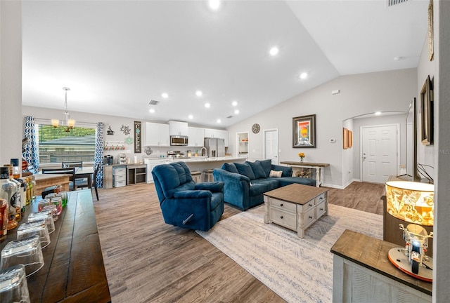 11330 SW 61st Cir, Ocala, FL 34476 - living area featuring light wood-style floors, lofted ceiling, a chandelier, and recessed lighting