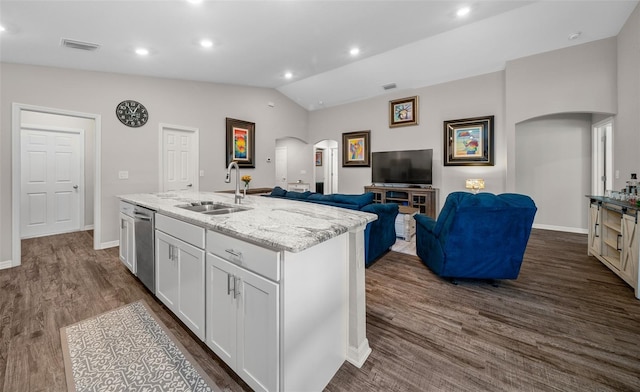 11330 SW 61st Cir, Ocala, FL 34476 - kitchen with arched walkways, white cabinetry, light stone countertops, dishwasher, and dark wood-style floors