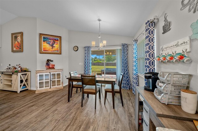 11330 SW 61st Cir, Ocala, FL 34476 - dining room with vaulted ceiling, wood finished floors, and a chandelier