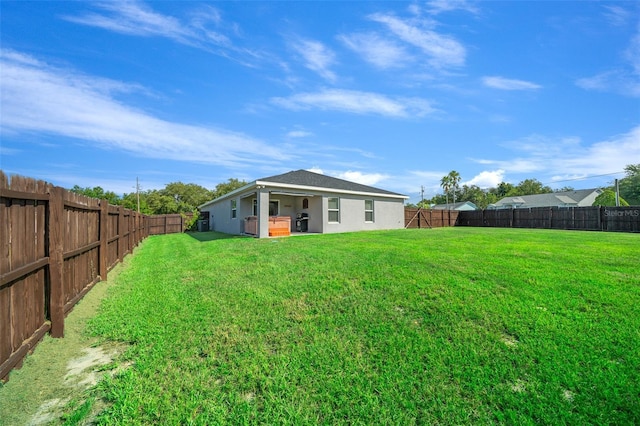 11330 SW 61st Cir, Ocala, FL 34476 - back of house with a fenced backyard, stucco siding, and a patio area
