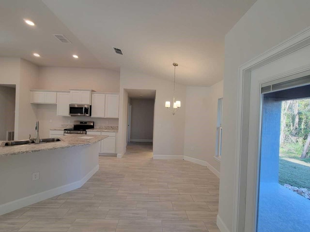 12384 SW 96th Ln, Dunnellon, FL 34432 - kitchen with appliances with stainless steel finishes, recessed lighting, white cabinetry, a chandelier, and hanging light fixtures