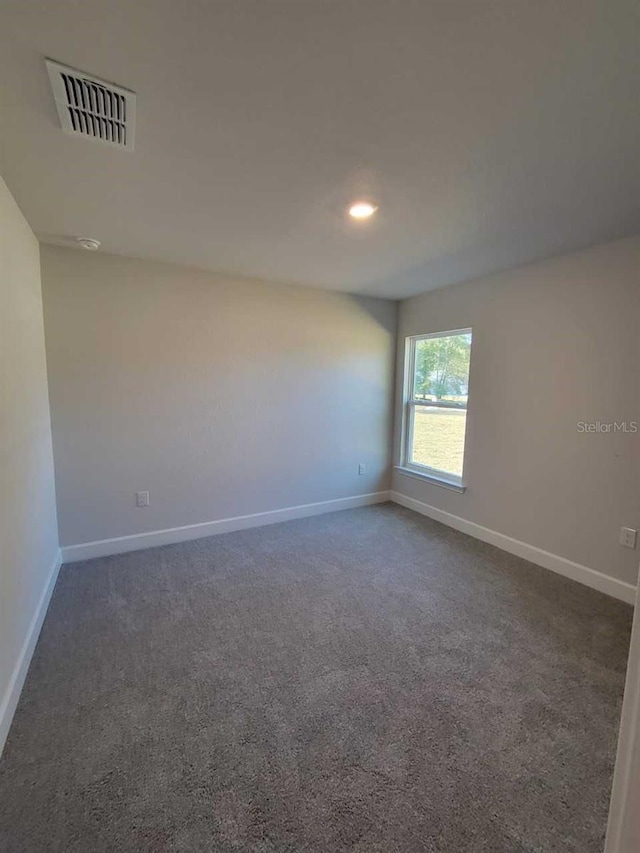 12384 SW 96th Ln, Dunnellon, FL 34432 - unfurnished room featuring dark carpet and baseboards