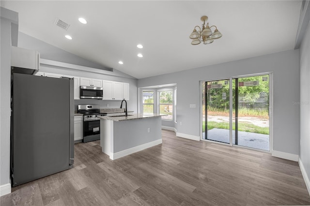 51 Pine Trace Loop, Ocala, FL 34472 - kitchen featuring appliances with stainless steel finishes, vaulted ceiling, a chandelier, white cabinets, and recessed lighting