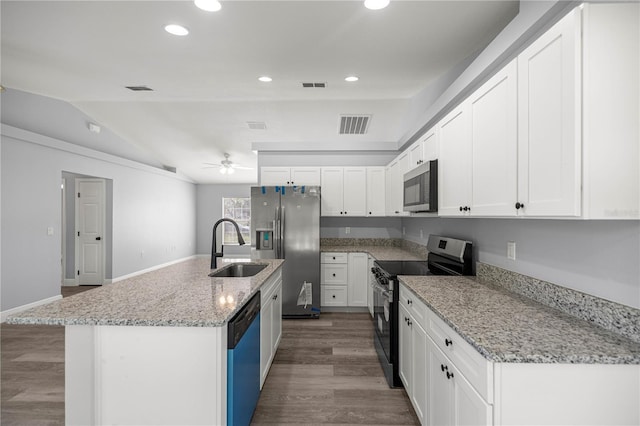 51 Pine Trace Loop, Ocala, FL 34472 - kitchen featuring stainless steel appliances, wood finished floors, a ceiling fan, lofted ceiling, and white cabinets