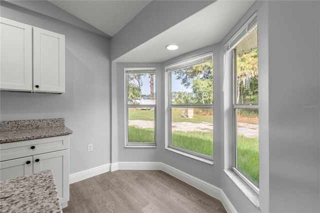 51 Pine Trace Loop, Ocala, FL 34472 - unfurnished dining area featuring plenty of natural light, wood finished floors, and vaulted ceiling