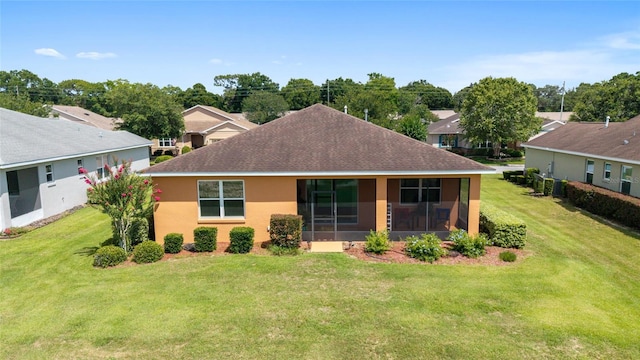 9236 SW 91st Court Rd, Ocala, FL 34481 - rear view of property with a yard, a shingled roof, stucco siding, and a sunroom