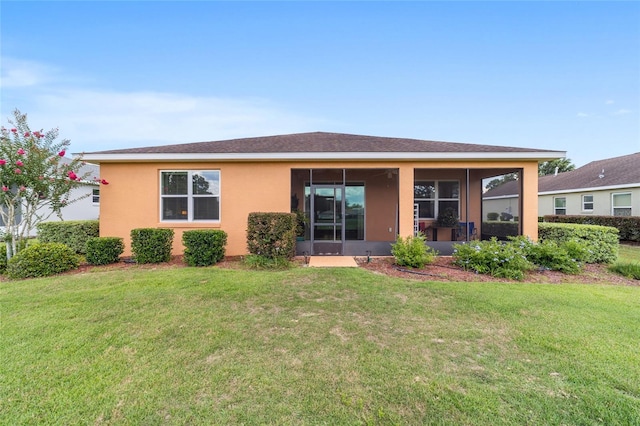 9236 SW 91st Court Rd, Ocala, FL 34481 - back of house featuring a sunroom, a lawn, and stucco siding