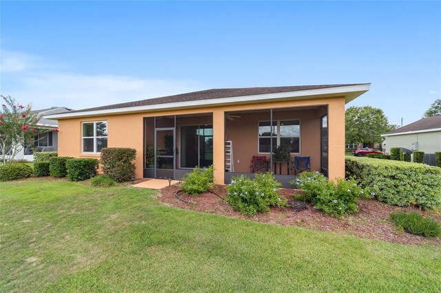 9236 SW 91st Court Rd, Ocala, FL 34481 - back of house featuring a yard and stucco siding