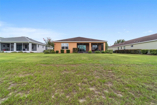 9236 SW 91st Court Rd, Ocala, FL 34481 - rear view of house with a lawn, stucco siding, and a sunroom