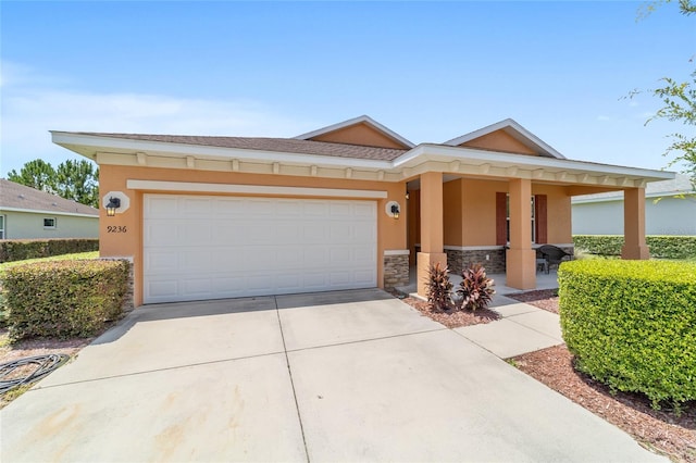 9236 SW 91st Court Rd, Ocala, FL 34481 - view of front facade featuring concrete driveway, stone siding, a garage, a porch, and stucco siding