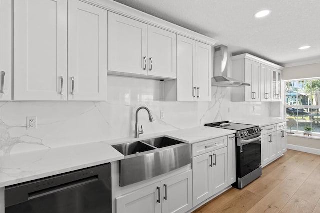 1860 NW 16th St, Crystal River, FL 34428 - kitchen with stainless steel range with electric cooktop, dishwashing machine, wall chimney range hood, recessed lighting, and white cabinetry