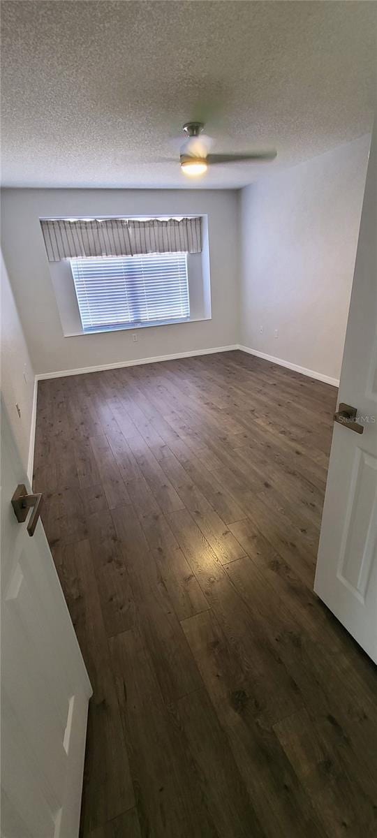 8771 SW 115th St, Ocala, FL 34481 - spare room with a textured ceiling and dark wood-style floors