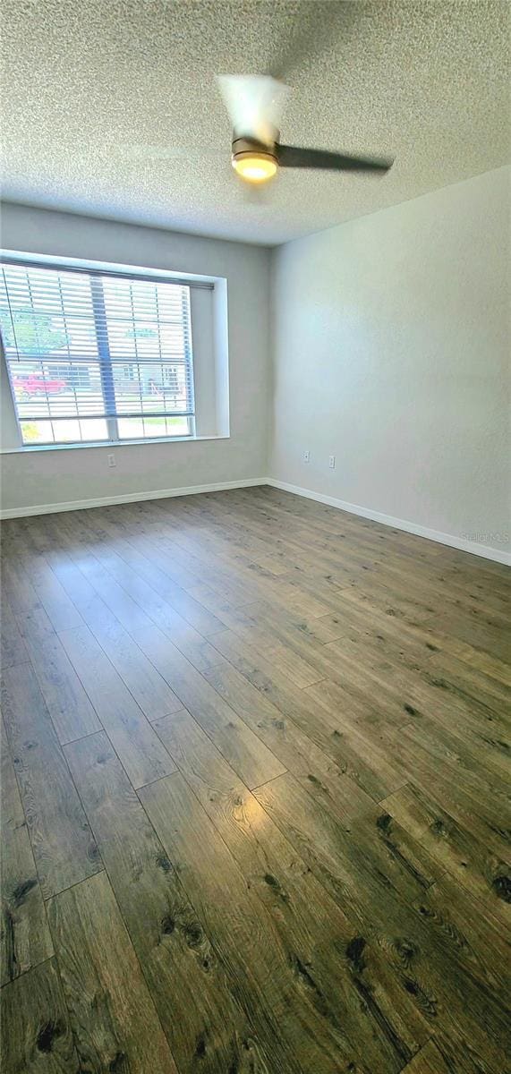 8771 SW 115th St, Ocala, FL 34481 - spare room featuring dark wood-type flooring and a textured ceiling