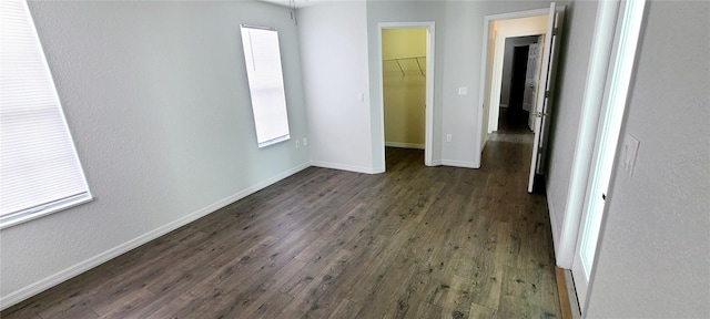 8771 SW 115th St, Ocala, FL 34481 - unfurnished bedroom featuring a spacious closet, dark wood-style flooring, and a closet
