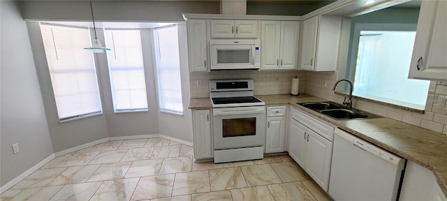 8771 SW 115th St, Ocala, FL 34481 - kitchen featuring white appliances, tasteful backsplash, white cabinetry, and light marble finish flooring