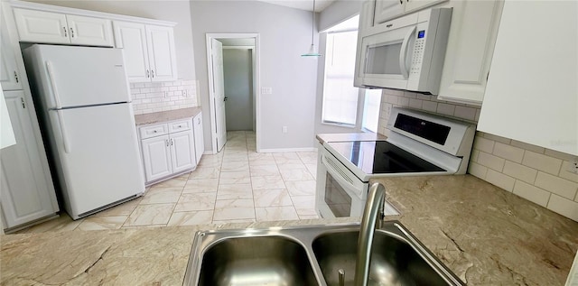 8771 SW 115th St, Ocala, FL 34481 - kitchen with white appliances, white cabinetry, tasteful backsplash, light stone countertops, and light marble finish floors