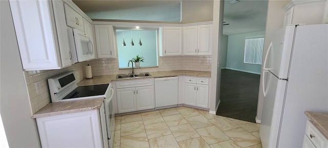 8771 SW 115th St, Ocala, FL 34481 - kitchen featuring white appliances, white cabinets, backsplash, and light countertops