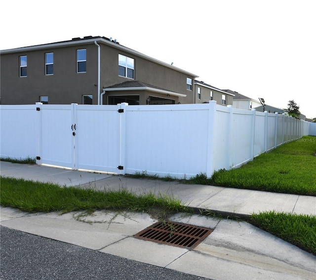 5962 SW 80th Ln, Ocala, FL 34476 - view of home's exterior featuring stucco siding and a gate