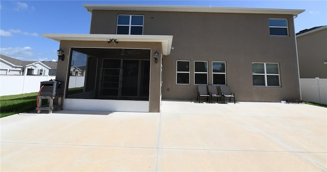 5962 SW 80th Ln, Ocala, FL 34476 - rear view of property featuring a sunroom, stucco siding, and a patio area