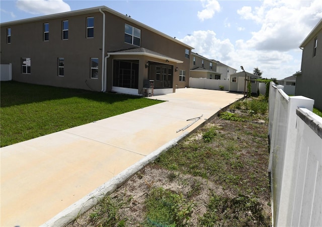 5962 SW 80th Ln, Ocala, FL 34476 - rear view of property featuring concrete driveway, stucco siding, a patio area, and a shed