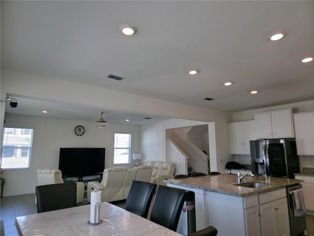 5962 SW 80th Ln, Ocala, FL 34476 - kitchen featuring refrigerator with ice dispenser, dishwasher, stone countertops, recessed lighting, and a center island with sink