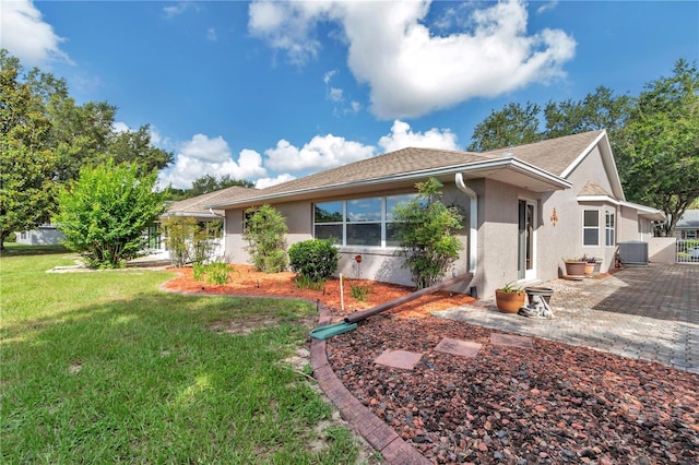 9069 SW 91st Cir, Ocala, FL 34481 - view of front of house featuring stucco siding, a front yard, and a patio area