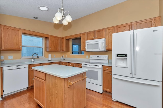 9069 SW 91st Cir, Ocala, FL 34481 - kitchen with white appliances, a chandelier, light wood-type flooring, light countertops, and a textured ceiling
