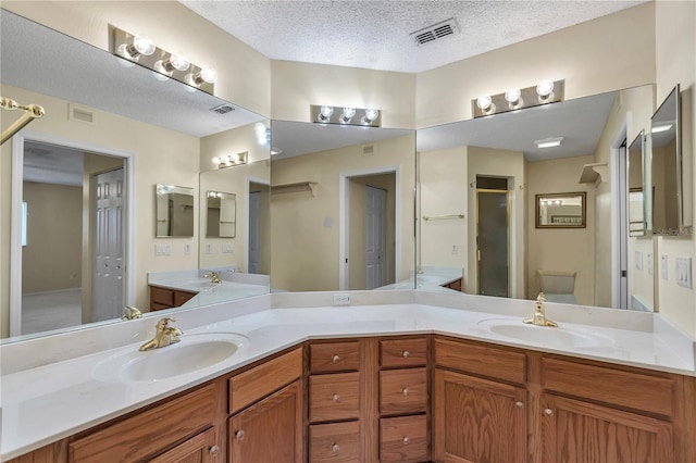 9069 SW 91st Cir, Ocala, FL 34481 - full bathroom featuring double vanity, a shower stall, and a textured ceiling