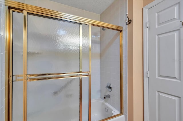 9069 SW 91st Cir, Ocala, FL 34481 - full bath featuring bath / shower combo with glass door and a textured ceiling