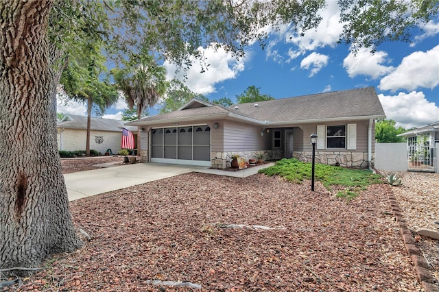 9069 SW 91st Cir, Ocala, FL 34481 - single story home with stone siding, a garage, driveway, and roof with shingles