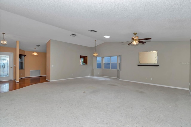 9069 SW 91st Cir, Ocala, FL 34481 - unfurnished living room with vaulted ceiling, carpet floors, a ceiling fan, and a textured ceiling