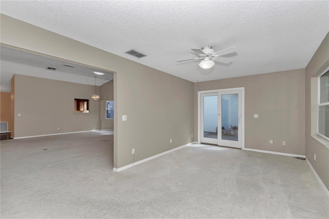 9069 SW 91st Cir, Ocala, FL 34481 - spare room featuring ceiling fan, light colored carpet, and a textured ceiling