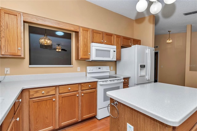 9069 SW 91st Cir, Ocala, FL 34481 - kitchen featuring white appliances, brown cabinets, light countertops, and decorative light fixtures