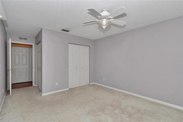 9069 SW 91st Cir, Ocala, FL 34481 - unfurnished bedroom featuring light colored carpet, a textured ceiling, and a ceiling fan