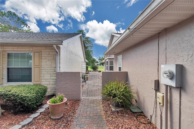 9069 SW 91st Cir, Ocala, FL 34481 - view of side of property featuring stucco siding and a gate