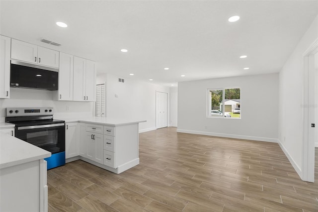 2817 Rheims Ave, Melbourne, FL 32935 - kitchen featuring appliances with stainless steel finishes, a peninsula, light countertops, light wood-type flooring, and recessed lighting