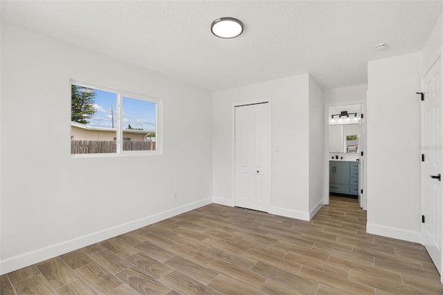 2817 Rheims Ave, Melbourne, FL 32935 - unfurnished bedroom featuring light wood-type flooring, a closet, and ensuite bathroom