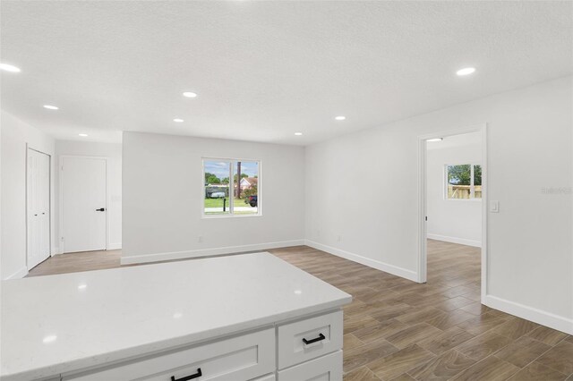 2817 Rheims Ave, Melbourne, FL 32935 - kitchen featuring light countertops, white cabinetry, recessed lighting, and light wood finished floors