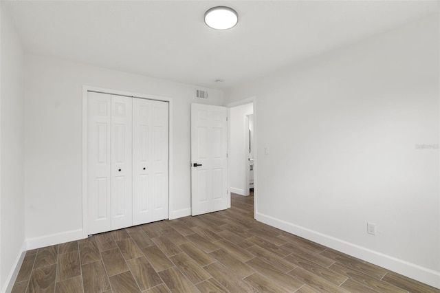 2817 Rheims Ave, Melbourne, FL 32935 - unfurnished bedroom featuring wood finished floors and a closet