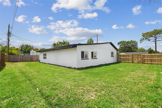 2817 Rheims Ave, Melbourne, FL 32935 - rear view of property with a fenced backyard and stucco siding