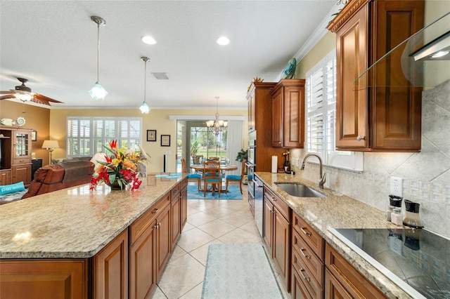 7814 SW 97th Cir, Ocala, FL 34481 - kitchen featuring brown cabinetry, crown molding, black electric cooktop, light stone countertops, and recessed lighting