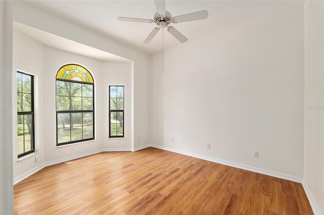 9180 SW 202nd Avenue Rd, Dunnellon, FL 34431 - unfurnished room with light wood-style floors, healthy amount of natural light, and a ceiling fan